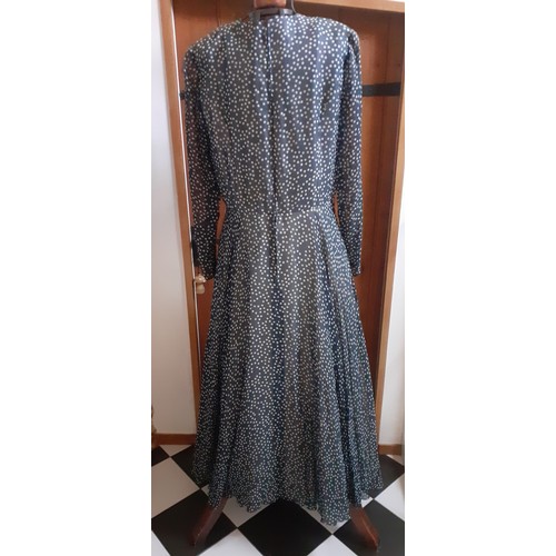 6 - Hardy Amies- A navy full length gown with white polka dot design throughout, having a double full le... 