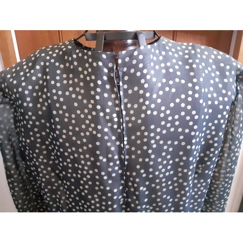 6 - Hardy Amies- A navy full length gown with white polka dot design throughout, having a double full le... 