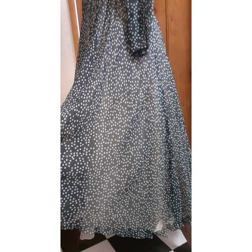 6 - Hardy Amies- A navy full length gown with white polka dot design throughout, having a double full le... 