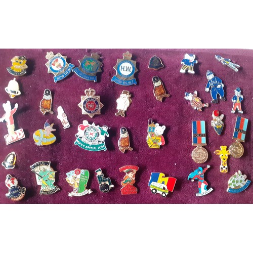 81 - A collection of police charity and other charity pin badges to include Magic Roundabout tie pins, ci... 