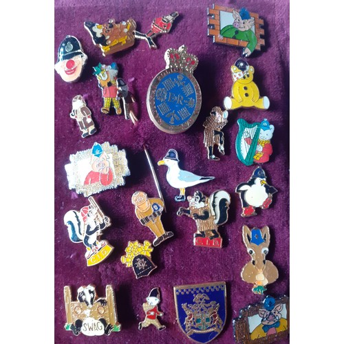 81 - A collection of police charity and other charity pin badges to include Magic Roundabout tie pins, ci... 