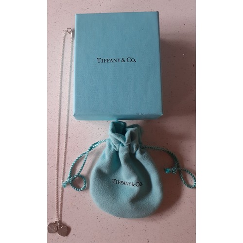 15 - Tiffany- A silver necklace having mini double heart shaped pendants, one with the inscription 'Retur... 