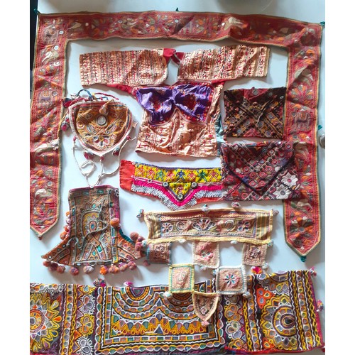 84 - A quantity of Banjara mirrored and embroidered bags, a traditional and elaborately embroidered India... 