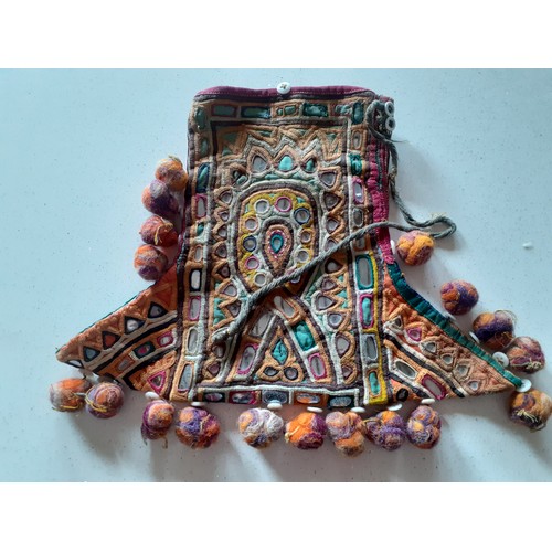 84 - A quantity of Banjara mirrored and embroidered bags, a traditional and elaborately embroidered India... 