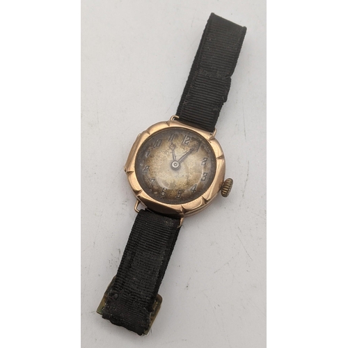 36 - A 9ct gold ladies manual wind wrist watch on a black fabric strap, total weight 16.1g
Location CAB 1... 