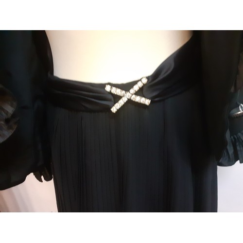 52 - Hartnell, British Designer- A black evening jacket with ruffled collar and cuffs approx 38