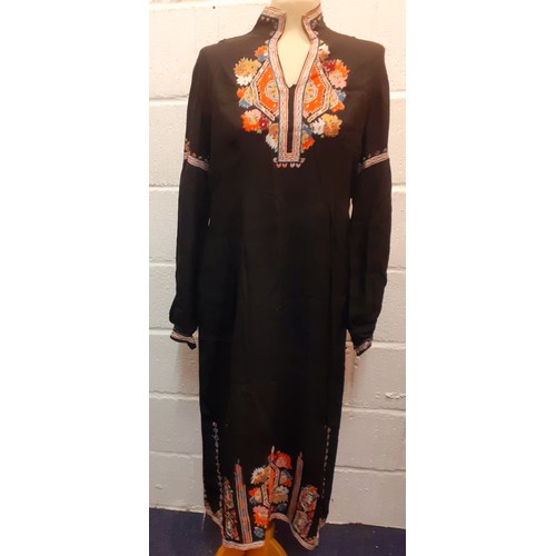 86 - A vintage black hand embroidered female kaftan, having bellow sleeves with hand embroidered cuffs, a... 