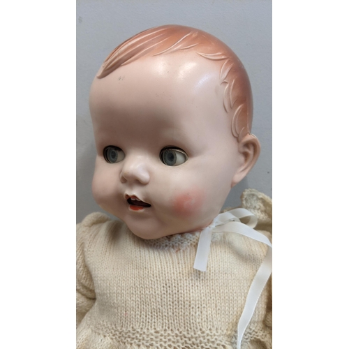 72 - A 1950's Pedigree doll with jointed arms & legs blue sleeping eyes and open mouth in original clothe... 