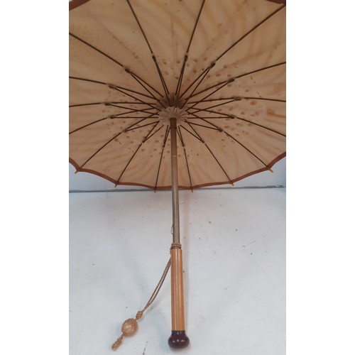 35 - An Edwardian parasol 'The Armstrong', British made, having a gold coloured silk fabric with hand pri... 