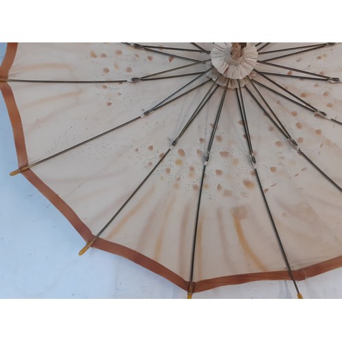 35 - An Edwardian parasol 'The Armstrong', British made, having a gold coloured silk fabric with hand pri... 