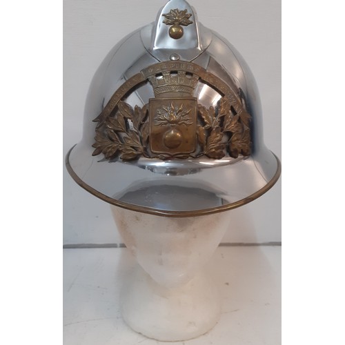 94 - A French fireman's polished chrome helmet with brass badge and mounts. Location:R1.1
If there is no ... 