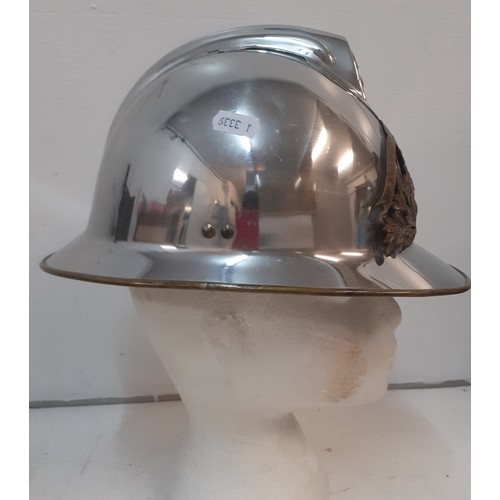 94 - A French fireman's polished chrome helmet with brass badge and mounts. Location:R1.1
If there is no ... 