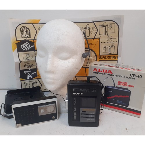 137 - A Retro Sony Walkman Mega Bass FM/AM radio cassette portable player with headphones together with an... 