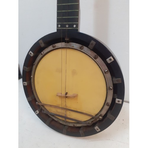 140 - A late 19th Century banjo A/F having mother of pearl inlay and a black wooden case. Location:RWF 
Co... 