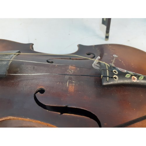 141 - A late 19th/early 20th Century violin A/F with bow A/F and black wooden case, no makers label to int... 