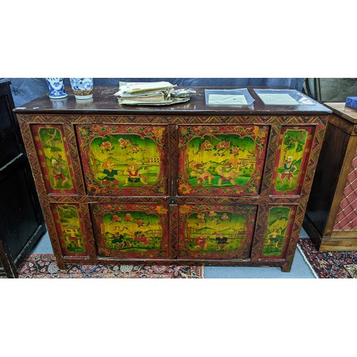 77 - A 19th century Tibetan cabinet, polychrome painted with panels depicting various deities in landscap... 