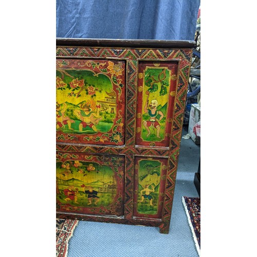 77 - A 19th century Tibetan cabinet, polychrome painted with panels depicting various deities in landscap... 