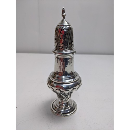 65 - An Edwardian silver sugar caster, Birmingham 1905, with a pierced top and gadrooned decoration, 19cm... 