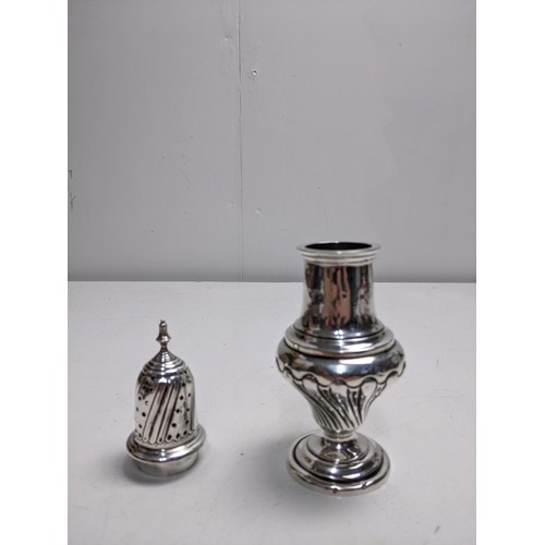 65 - An Edwardian silver sugar caster, Birmingham 1905, with a pierced top and gadrooned decoration, 19cm... 