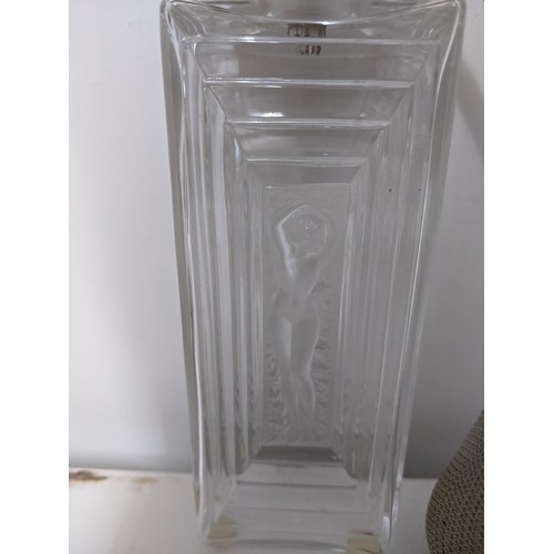 3 - Lalique- A glass perfume atomiser with a nude woman, in a stepped recessed panel to the front and ba... 