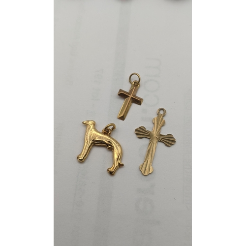 11 - Mixed 9ct gold jewellery to include a pendant fashioned as a greyhound dog, along with two cross pen... 