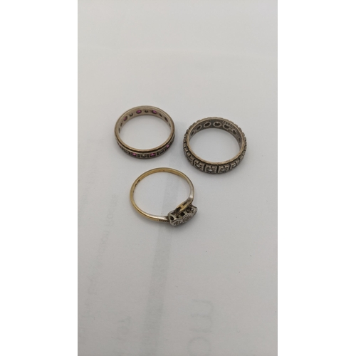 12 - Three gold ladies rings to include an 18ct gold platinum and diamond ring 2.1g together with two 9ct... 