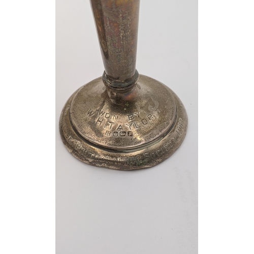 55 - A silver weighted candlestick and vase, each engraved 
Location:A2T
If there is no condition report ... 