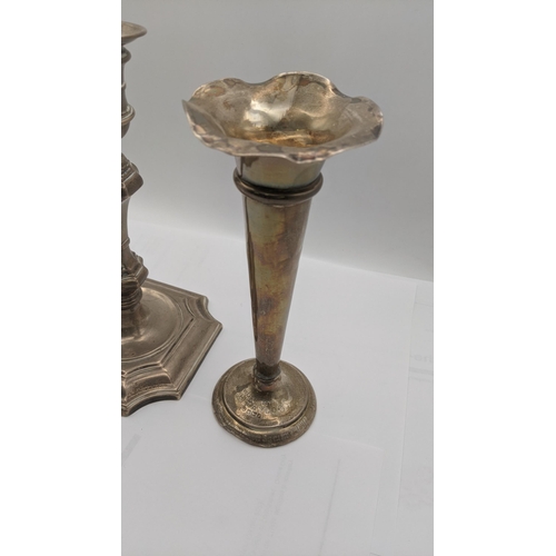 55 - A silver weighted candlestick and vase, each engraved 
Location:A2T
If there is no condition report ... 