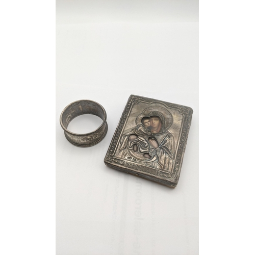 63 - A silver framed icon having embossed decoration 9.3cmL x 7.4cmW together a silver napkin ring hallma... 