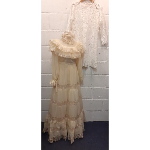 99 - A 1970's cream wedding dress UK10 with tiered skirt and lace insertions, together with a white tiara... 