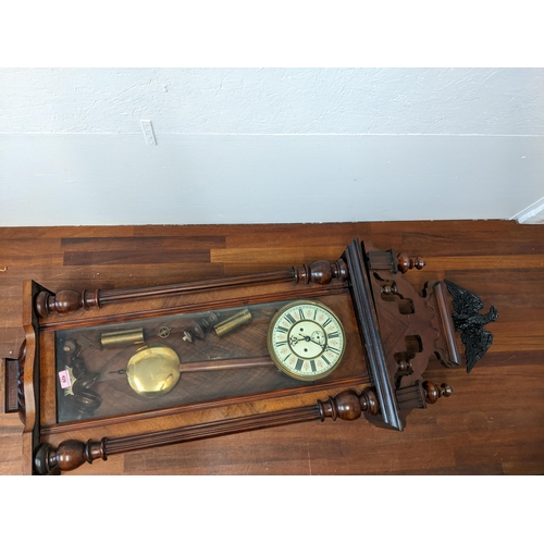 303 - A late 19th century walnut cased Vienna regulator style clock, surmounted by an eagle, with weights ... 