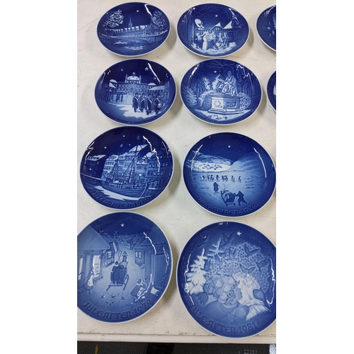 100 - A collection of Royal Copenhagen blue and white collectors plates to include mostly yearly Christmas... 