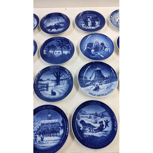 100 - A collection of Royal Copenhagen blue and white collectors plates to include mostly yearly Christmas... 