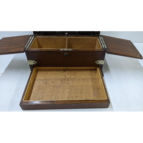 108 - An early 20th century oak and silver plate tantalus with two compartments without key and a secret d... 