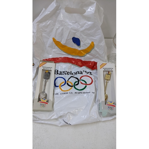 110 - Memorabilia from the Barcelona 1992 Olympics to include two boxed Cucharita spoons and a carrier bag... 