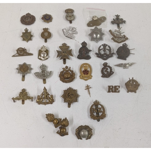 123 - A collection of cap badges to include WWII era South African Service Corps badge, Middlesex Regiment... 