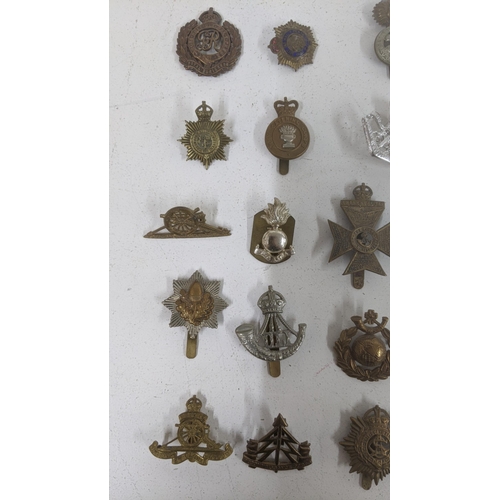 123 - A collection of cap badges to include WWII era South African Service Corps badge, Middlesex Regiment... 