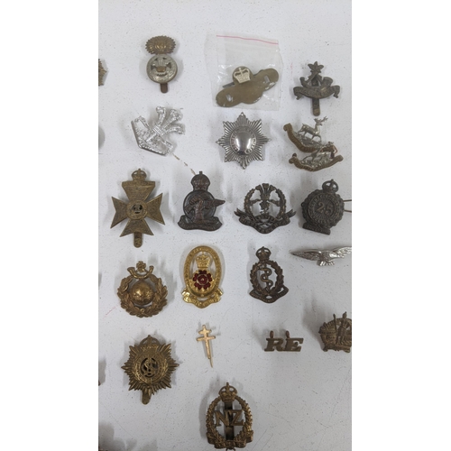 123 - A collection of cap badges to include WWII era South African Service Corps badge, Middlesex Regiment... 