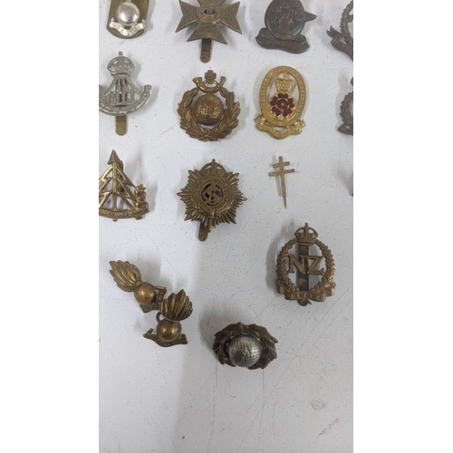 123 - A collection of cap badges to include WWII era South African Service Corps badge, Middlesex Regiment... 