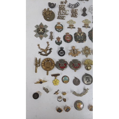 124 - A mixed lot of collar and cap badges to include Kings own Yorkshire Light Infantry, Royal Naval Divi... 