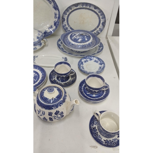 126 - A mixed lot of blue and white ceramics to include an Old Willow tea pot and others together with thr... 