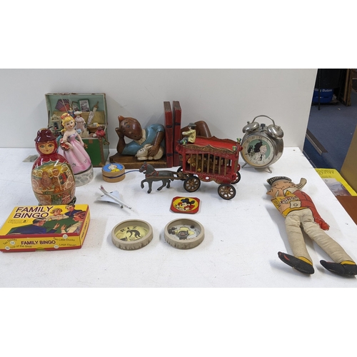 87 - A collection of vintage toys to include a model circus carriage title 'overland circus' two music bo... 