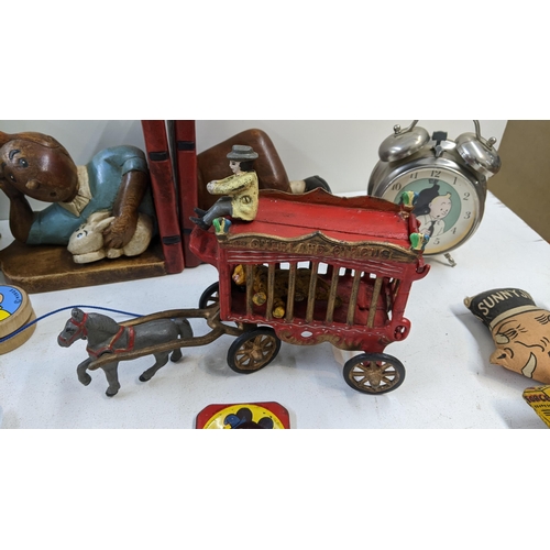 87 - A collection of vintage toys to include a model circus carriage title 'overland circus' two music bo... 