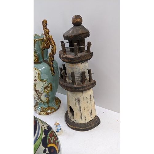 88 - A mixed lot to include twin Victorian jugs, A/F, a wooden lighthouse, a studio pottery vase, a Mexic... 