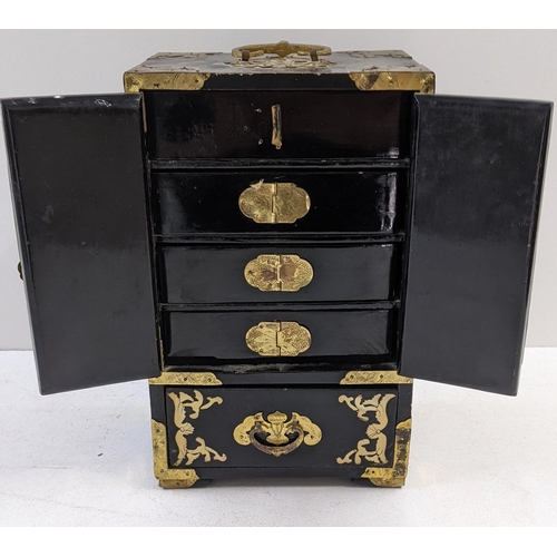 89 - An oriental, black lacquered jewellery cabinet with hinged doors and five compartments, A/F
Location... 