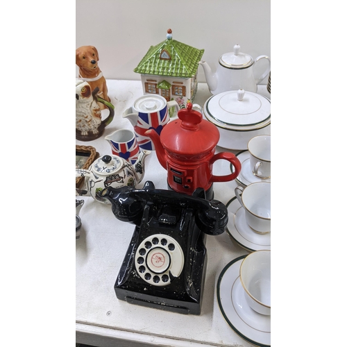 96 - A mixed lot to include a Boots Hanover Green dinner service, Novelty teapots, a Regency style tea ca... 