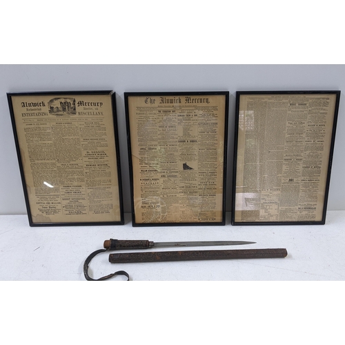 97 - A WWI era dagger set in a leather sheath, together with three frame newspaper pages form 'The Alnwic... 