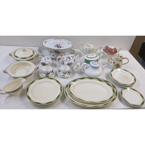 99 - A collection of dinner and tea ware to include a crescent ivory green and white part dinner service,... 