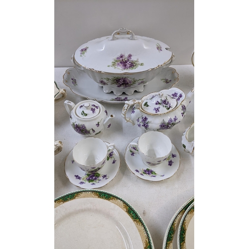 99 - A collection of dinner and tea ware to include a crescent ivory green and white part dinner service,... 