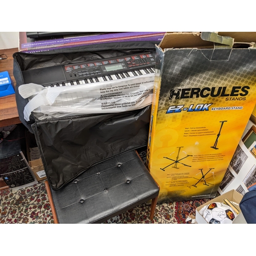 14 - A Yamaha PSR E203, a Casio Keyboard, stands, a stool and related items
Location: G
If there is no co... 